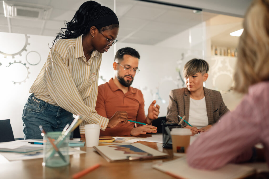 Employees collaborating during a workplace meeting focused on teamwork and communication