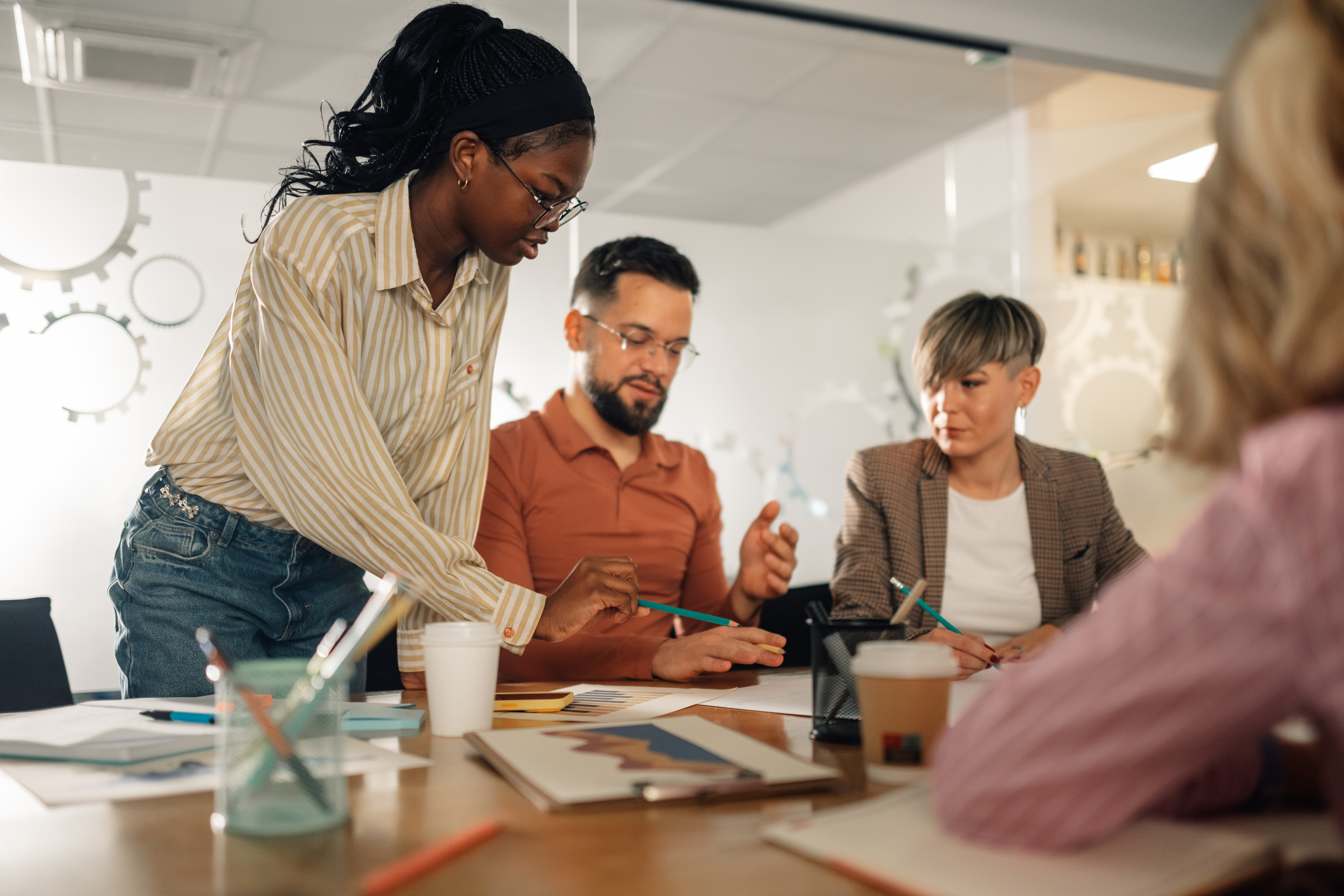 Employees collaborating during a workplace meeting focused on teamwork and communication